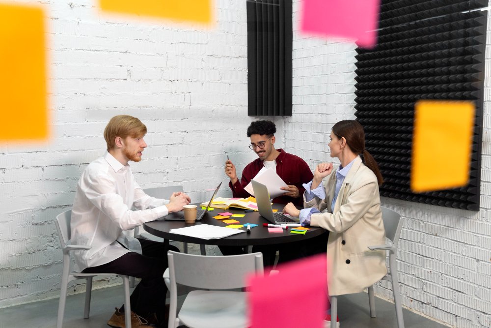 A marketing team brainstorming creative digital strategies in Digital Marketing Agency on a laptop.